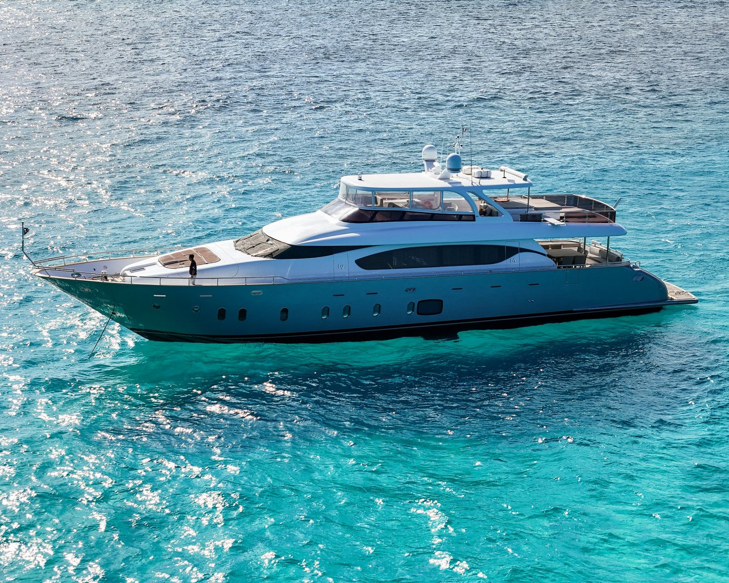 A motor yacht at anchor on turquoise water